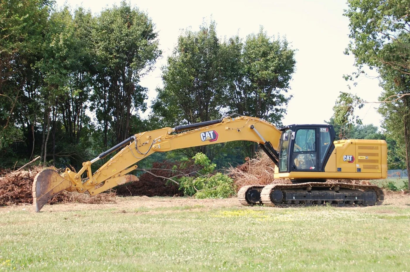Excavator working beside trees